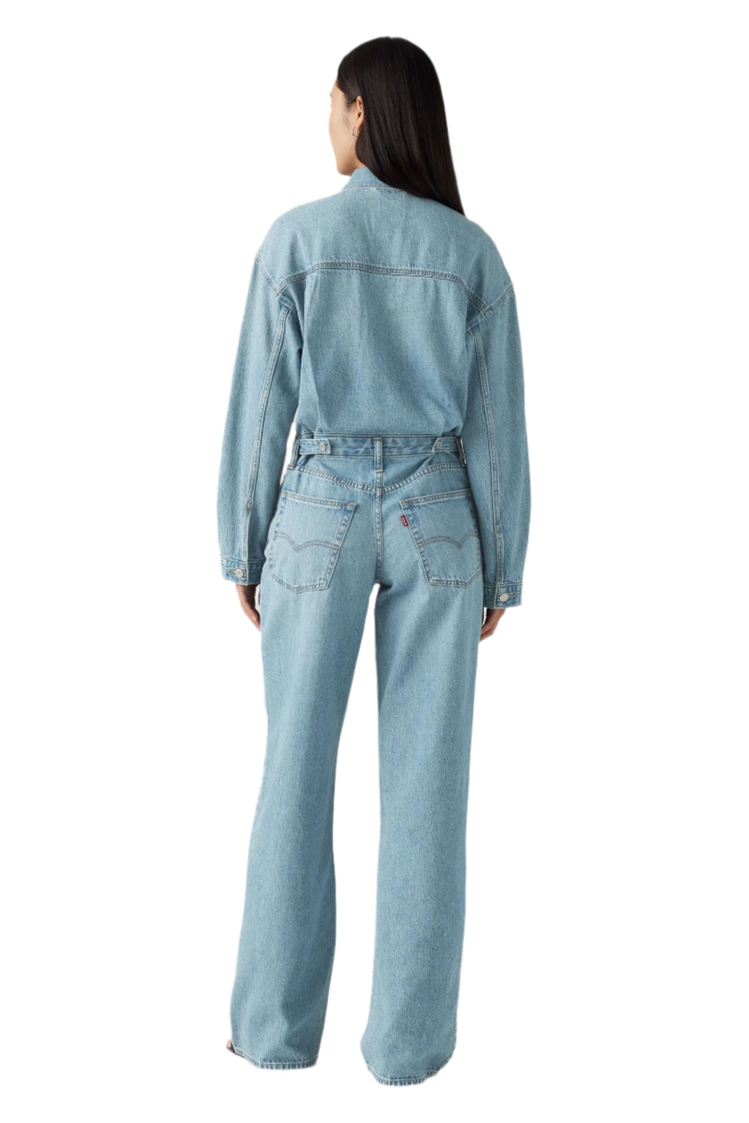 Person wearing a light blue denim jumpsuit.