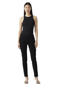 A woman standing straight, wearing a black tank top and black Levi's 312 Shaping Slim Jeans in a mid-rise slim fit style.