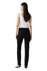 Woman wearing a white top and black pants on a white background
