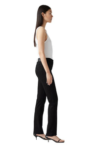 Woman wearing a white top and black pants on a white background