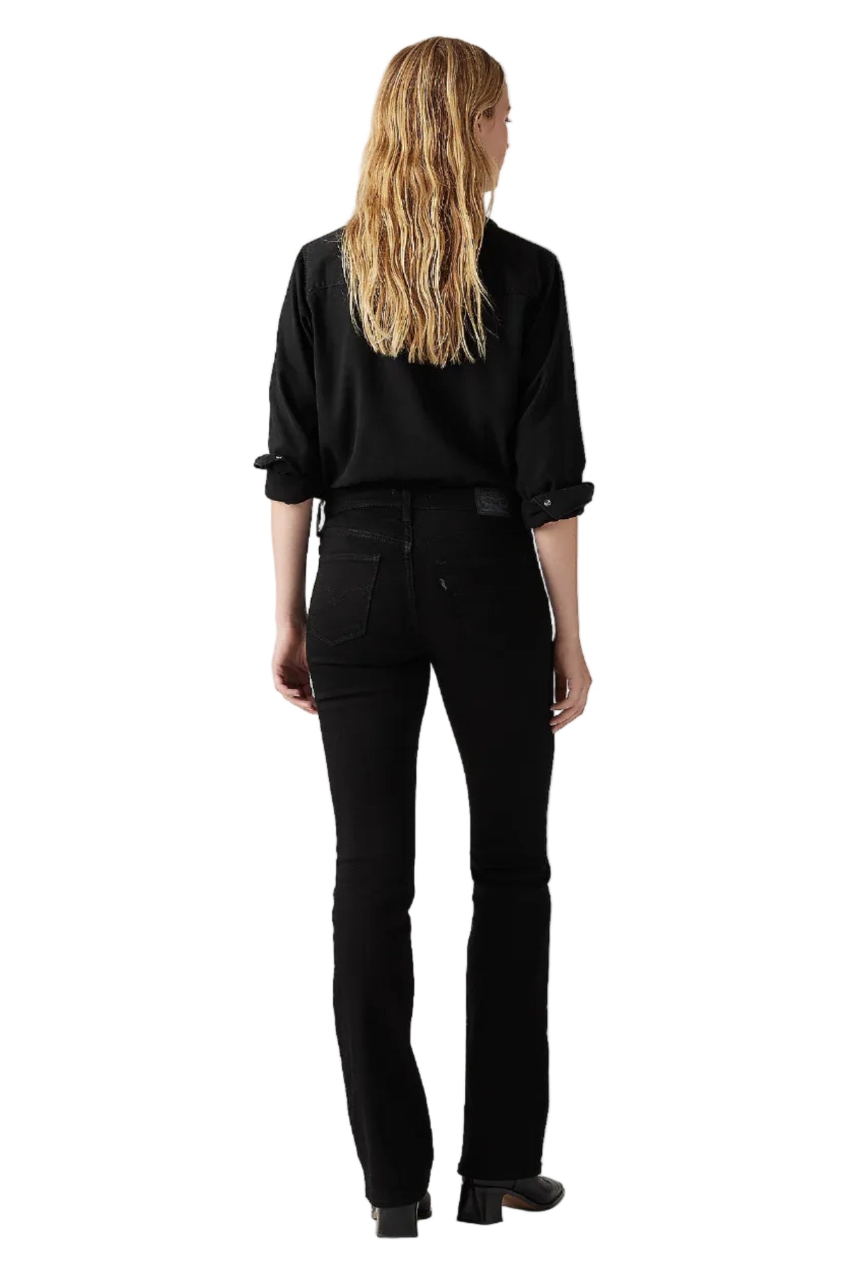 Person wearing a black outfit on a plain background