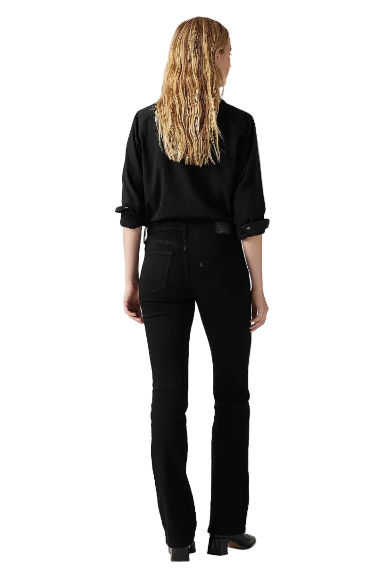 Person wearing a black outfit on a plain background