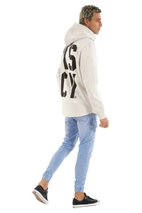 Person wearing a white hoodie with text on the back and light blue jeans, standing against a white background