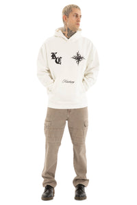 Person wearing a white hoodie with Kiss Chacey designs and text, paired with beige cargo pants on a light gray background.