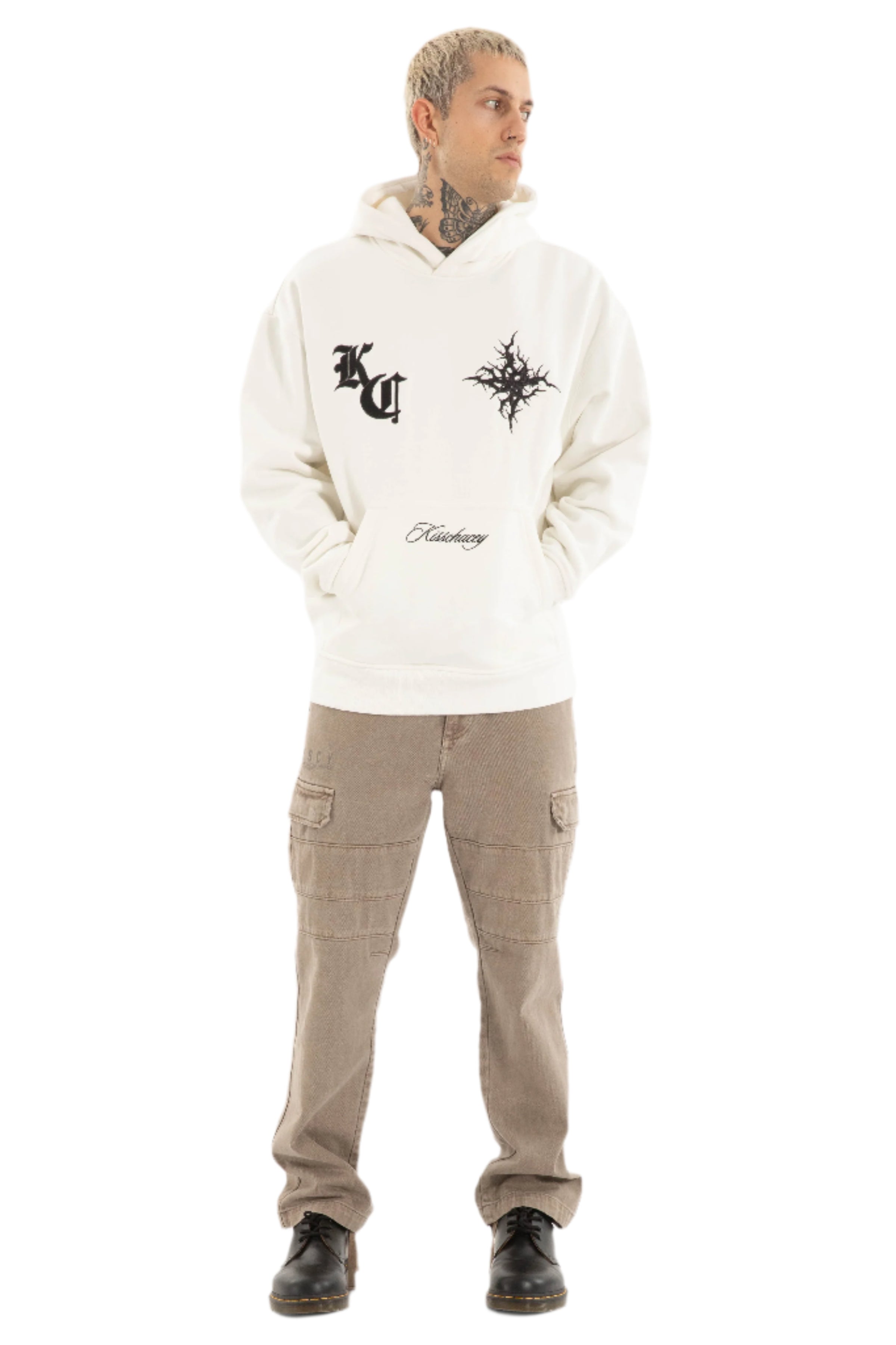 Person wearing a white hoodie with Kiss Chacey designs and text, paired with beige cargo pants on a light gray background.