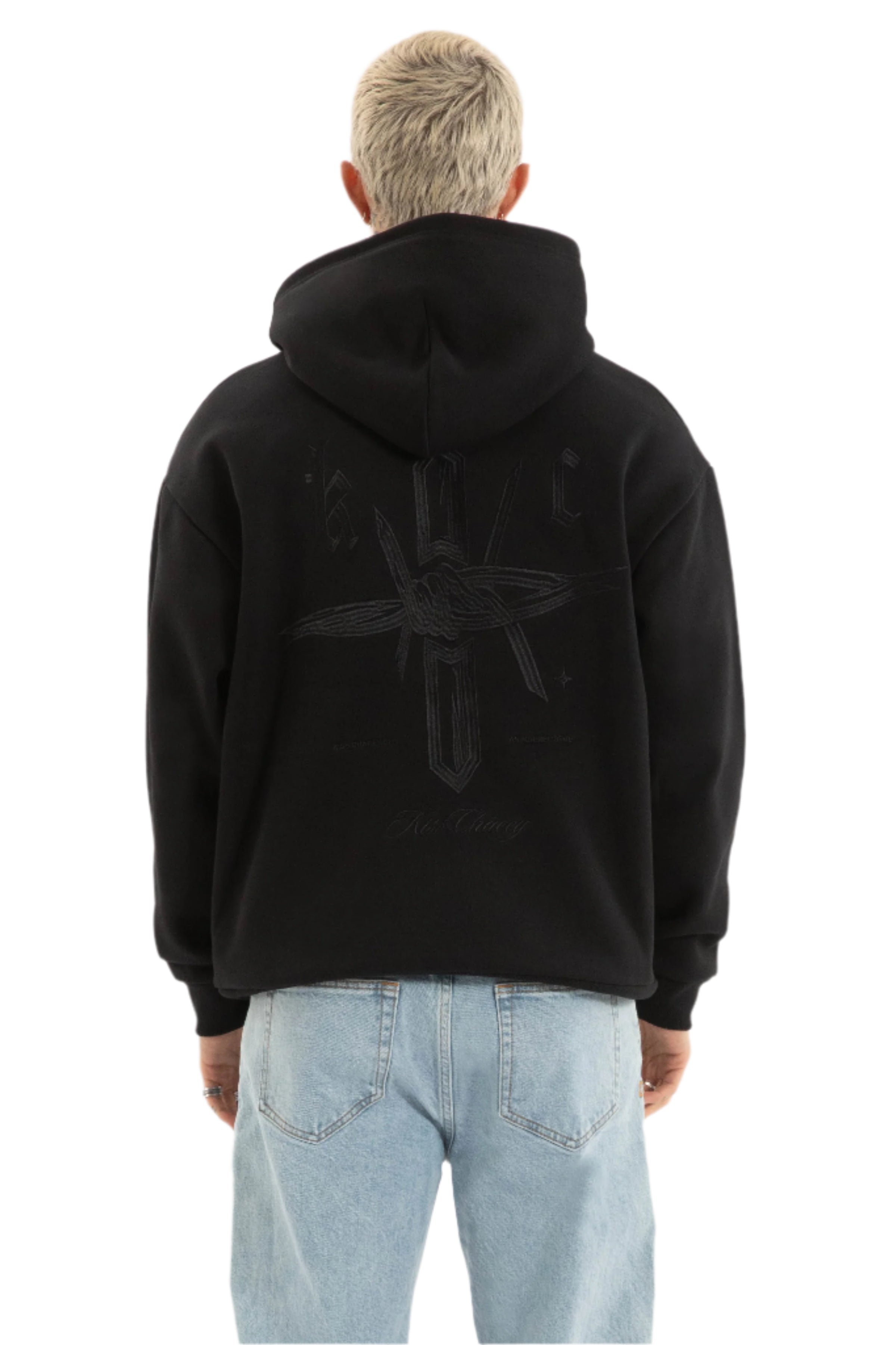 Person wearing a black hoodie with a logo on the back against a light gray background