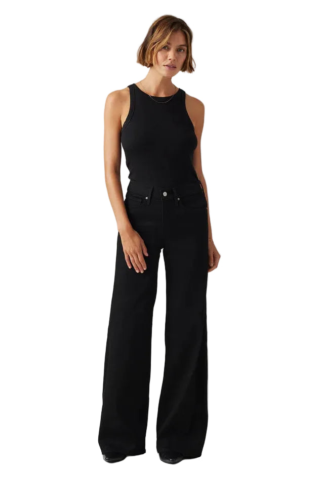 Woman wearing a black sleeveless top and wide-leg pants on a white background