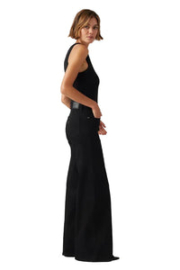 Woman wearing a black sleeveless top and wide-leg pants on a white background