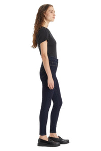 Woman wearing black leggings and a black t-shirt on a white background