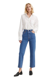 Person wearing a white shirt and blue jeans on a white background