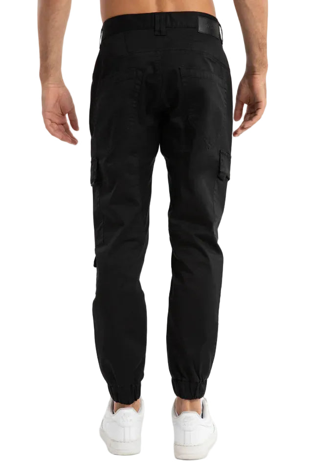 Black cargo pants worn by a person on a light gray background