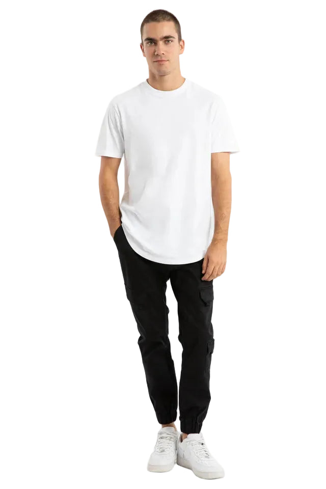 Man wearing a white t-shirt and black pants on a plain background