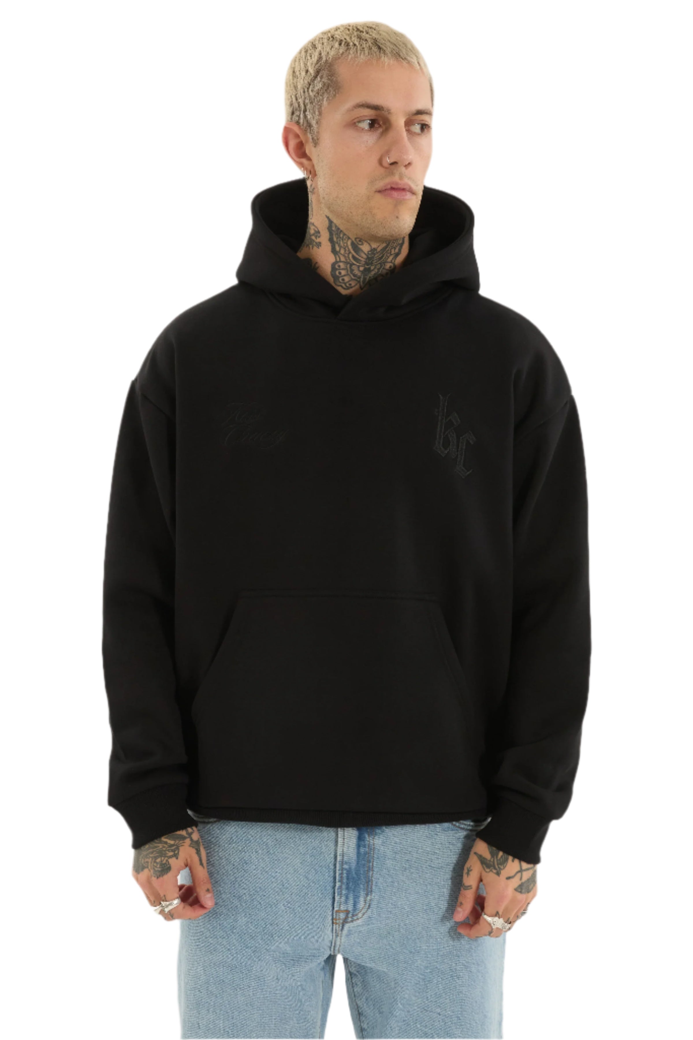 Person wearing a black hoodie with a logo on a white background
