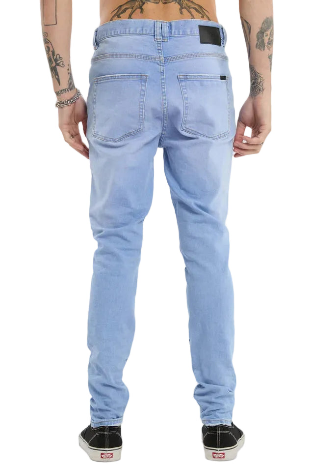 Light blue jeans worn by a person on a white background