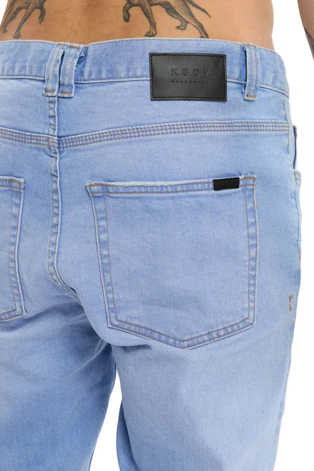 Light blue jeans with a brand label on a white background
