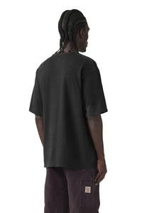Person wearing a black t-shirt and dark pants on a plain background