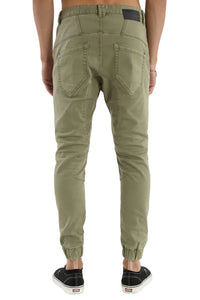 Person wearing olive green jogger pants on a white background