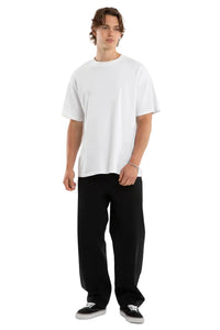 Person wearing a white t-shirt and black pants on a plain background