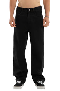 Person wearing black jeans on a plain background