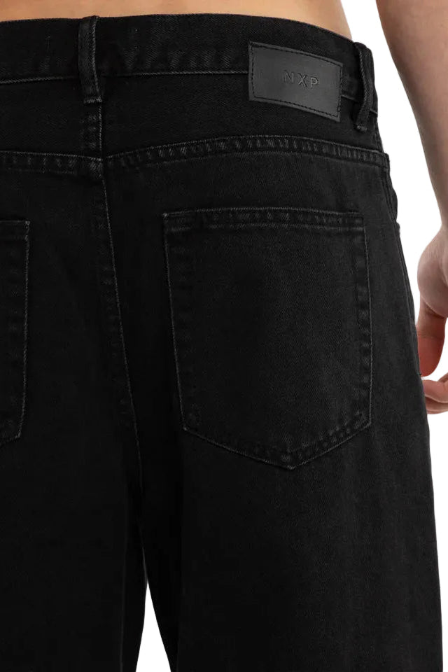 Black pants with a brand label on a white background