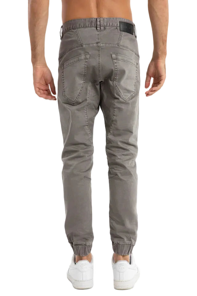 Gray jogger pants worn by a person on a white background