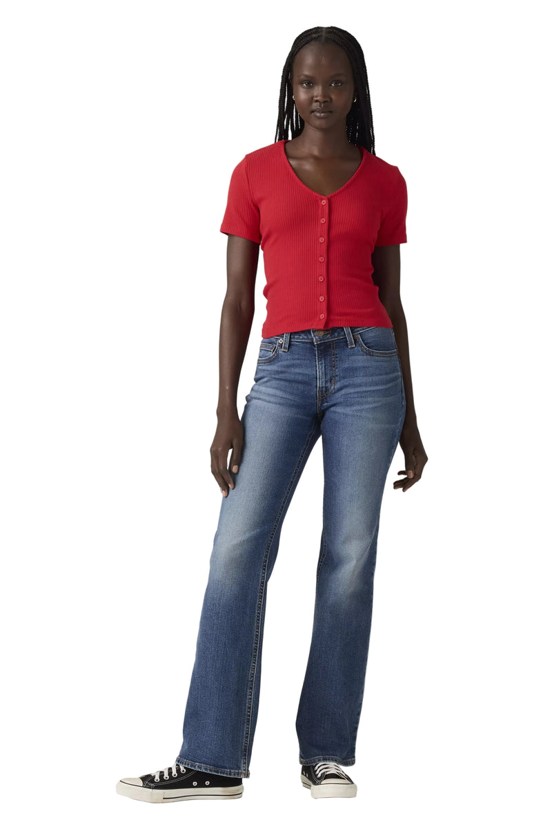 Person wearing a red shirt and blue jeans on a plain background