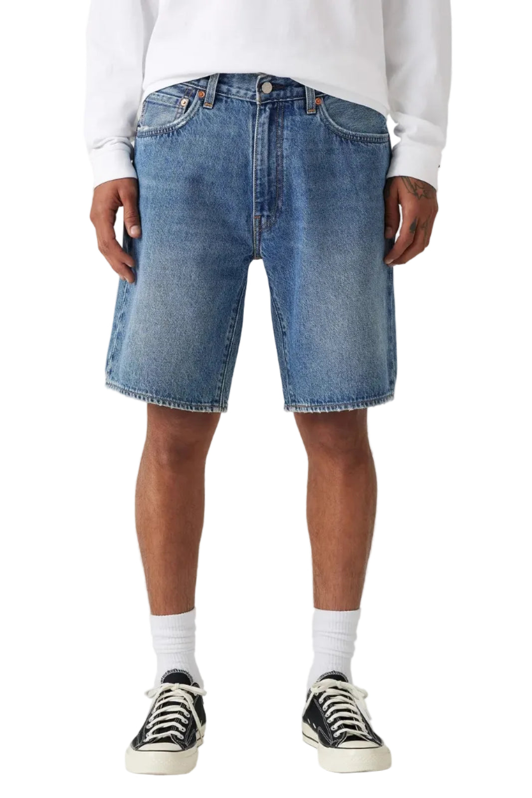 Person wearing blue denim shorts on a white background