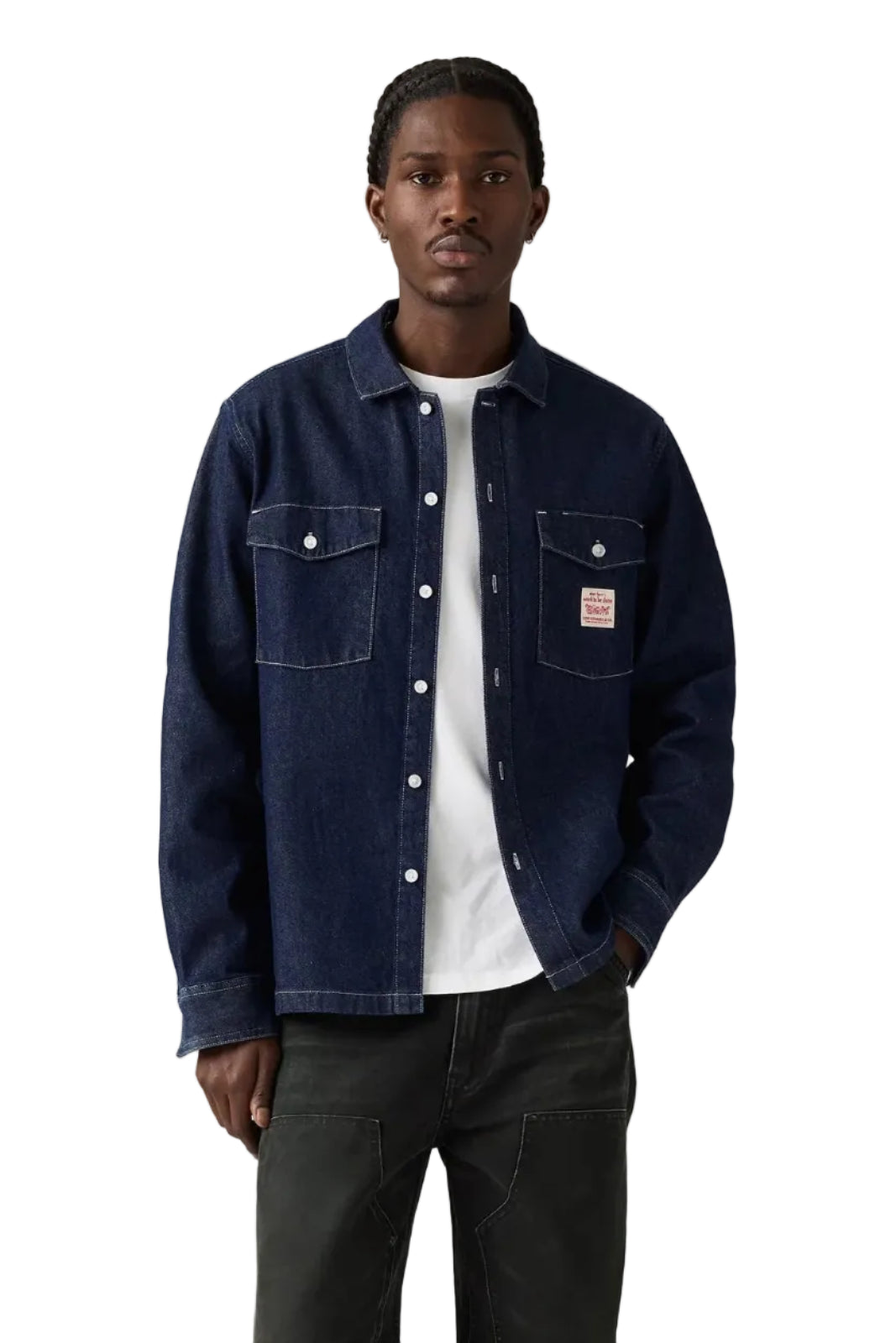 Man wearing a dark blue denim jacket over a white shirt on a plain background