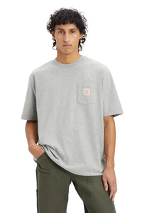 Person wearing a gray t-shirt with a small logo on a plain background