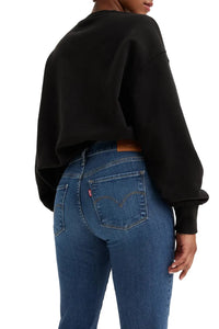 Person wearing a black sweatshirt and blue jeans on a white background