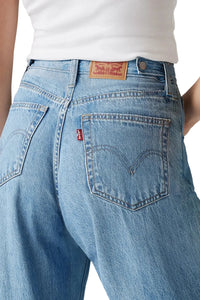 Blue jeans with a Levi's logo on a plain background