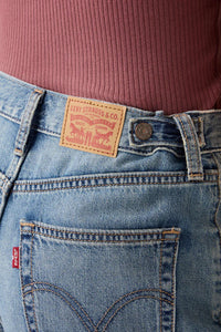 Close-up of blue jeans with Levi's branding on a blurred background