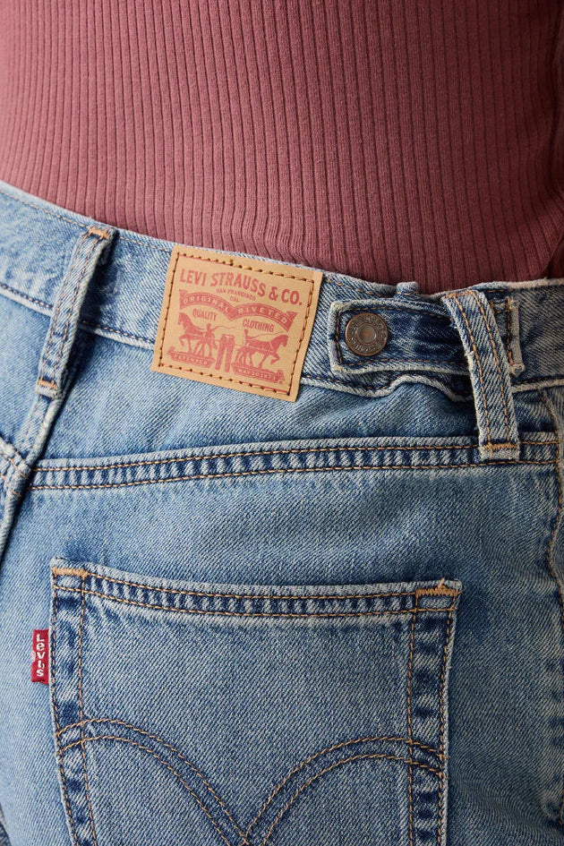 Close-up of blue jeans with Levi's branding on a blurred background