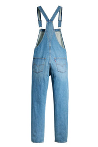 Blue denim overalls on a white background