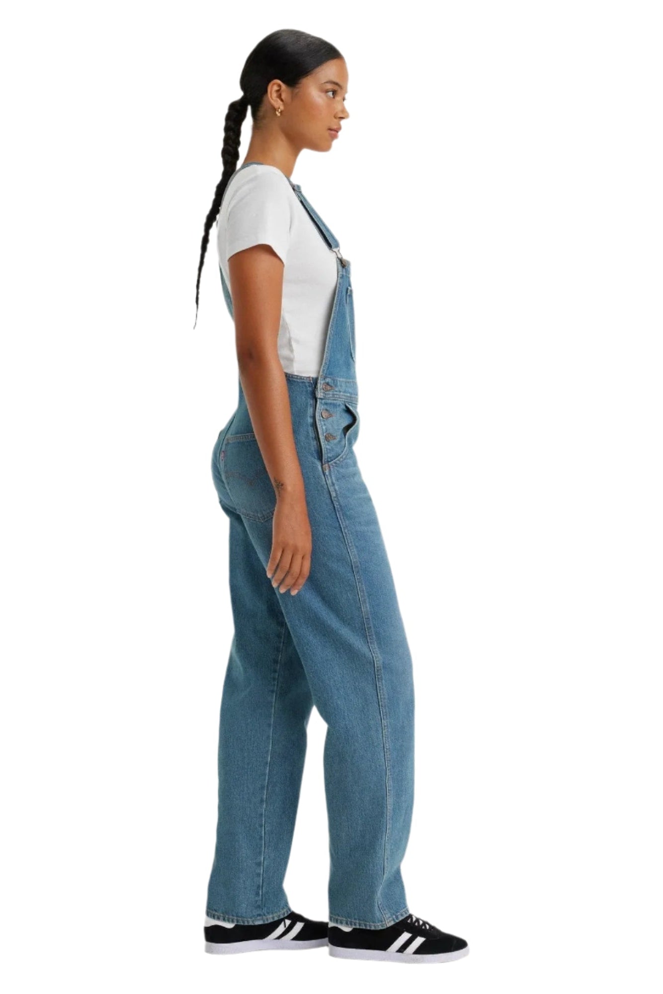 Person wearing blue denim overalls on a white background