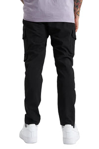 Person wearing black cargo pants and white sneakers on a white background