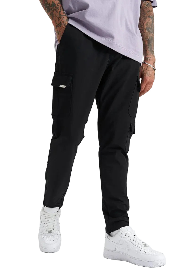 Person wearing black cargo jogger pants and white sneakers on a white background
