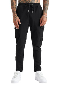 Person wearing black cargo pants and white sneakers on a light gray background