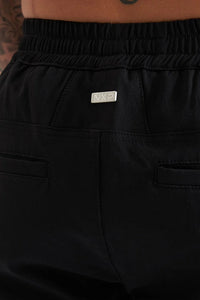 Black pants with a brand logo on a white background