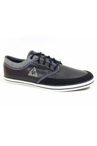 A black Le Coq Sportif sneaker with felt trim, metal eyelets, and round laces on a white background.