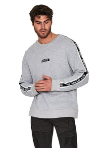 A male model wearing a grey marle sweatshirt with KSCY branding on the sleeves.